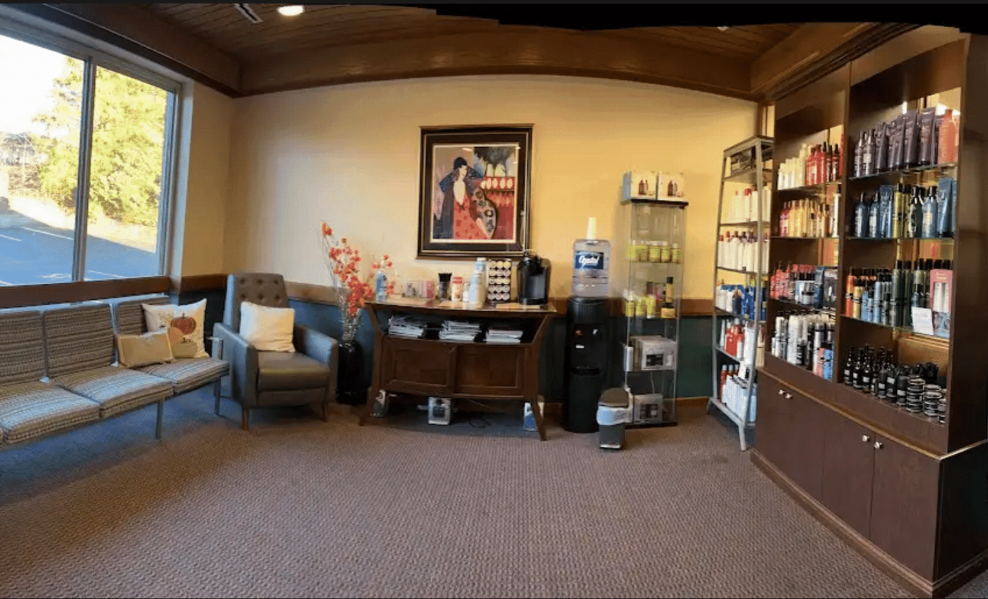 A waiting room with chairs, a water dispenser, and shelves full of hair products.
